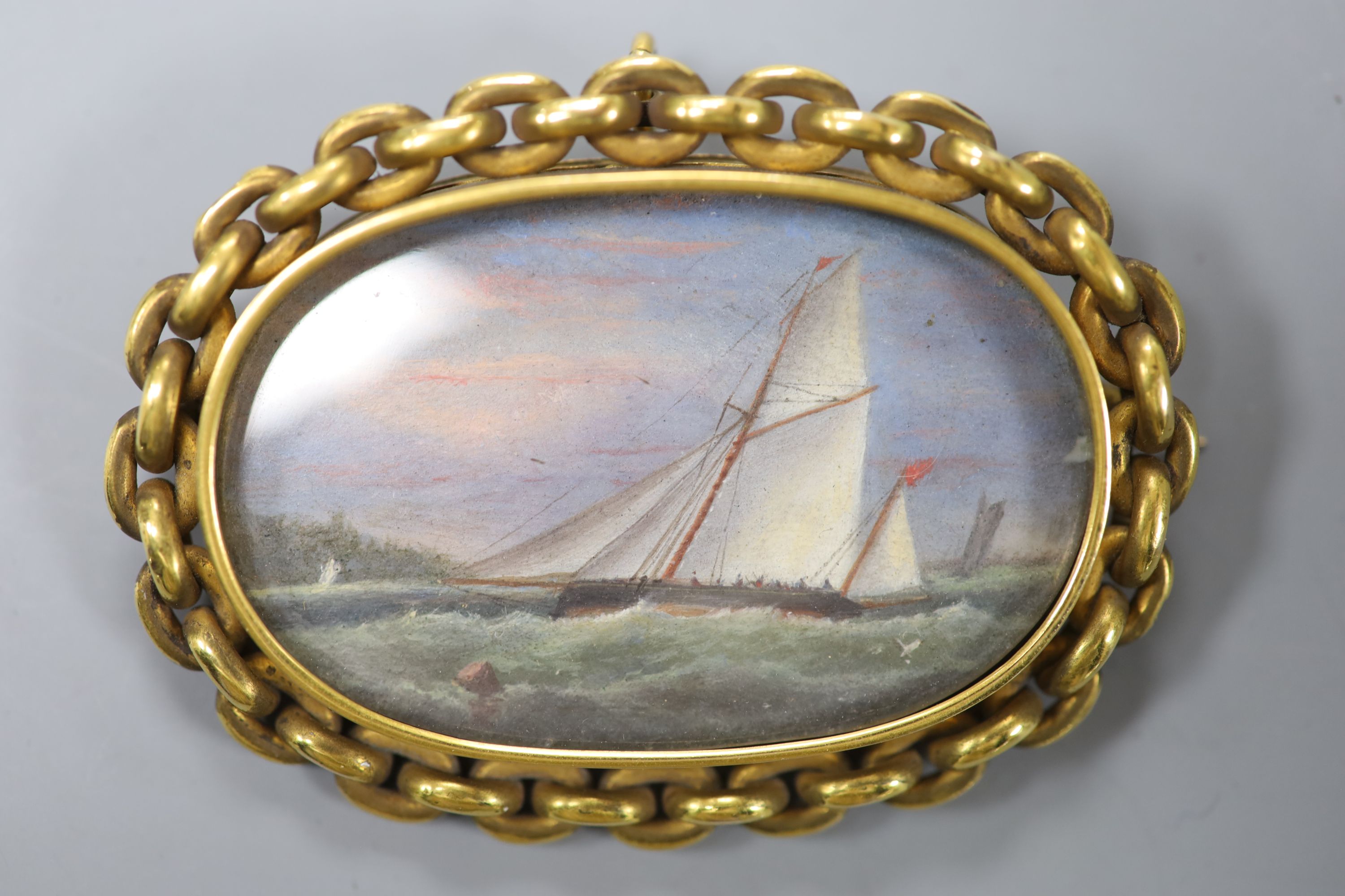 A Victorian oil on ivory miniature of a racing yacht at sea, the reverse inscribed A.W.Fowles, Bude, IOW 4 x 6cm.